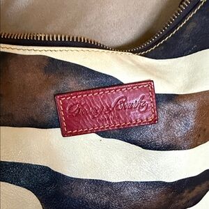 Dooney & Bourke Cream and Black Striped Hobo with Red Logo Patch